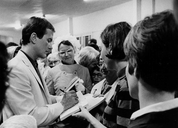 Pat Boone signing autographs. Seminar location is uncertain.
